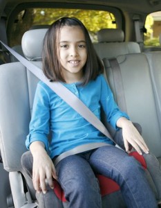 Child in backless booster seat.