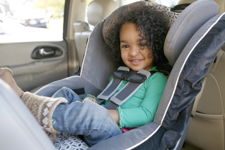 Toddler riding in rear-facing convertible car seat.